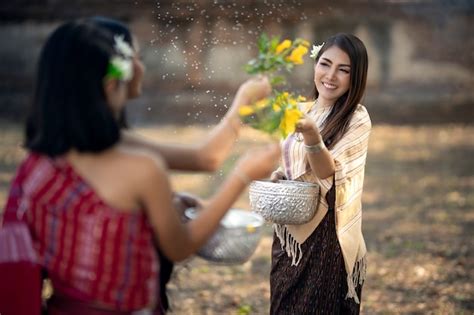 premium photo songkran festival the girl is splashing water and joining the thai new year