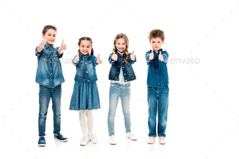 Full Length View Of Four Kids In Denim Clothes Showing Thumbs Up