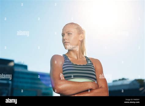Portrait Of A Confident Young Runner Standing Looking Away With Her