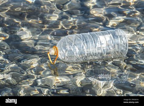 Empty Plastic Bottle Container Floating In The Sea Pollution Concept