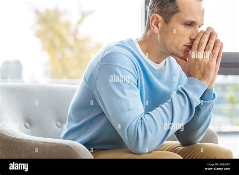 Cheerless Gloomy Man Holding His Hands Together Stock Photo Alamy
