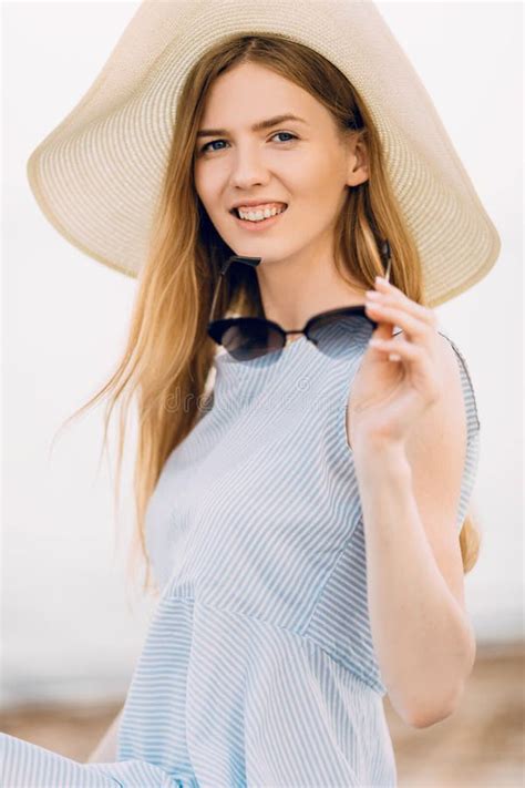 Portrait Of A Beautiful Summer Girl In Sunglasses And A Summer Hat Relaxing And Posing On The