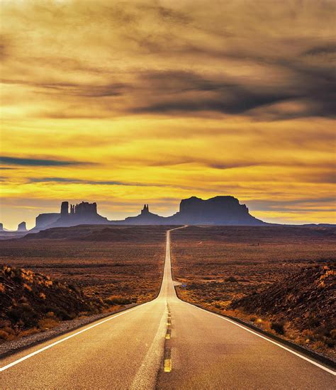 Desert Road Leading To Monument Valley At Sunset Photograph By Miroslav