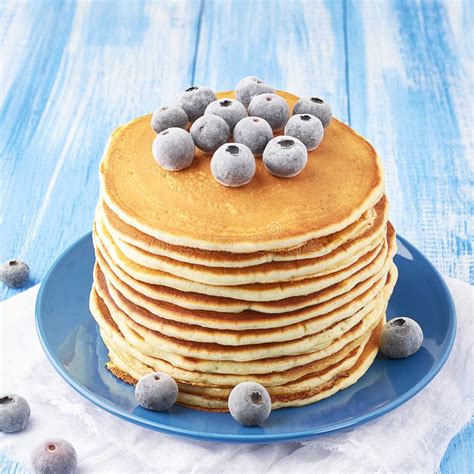 Stack Of Pancakes On A Blue Plate With Frozen Blueberry Stock Photo