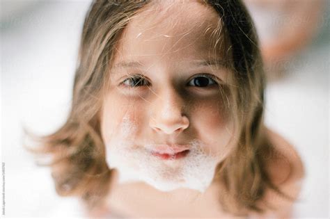 Cute Young Girl With Suds On Her Face By Stocksy Contributor Jakob