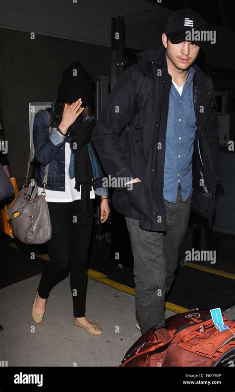 Ashton Kutcher And Mila Kunis Arrive At Los Angeles International Lax Airport Featuring
