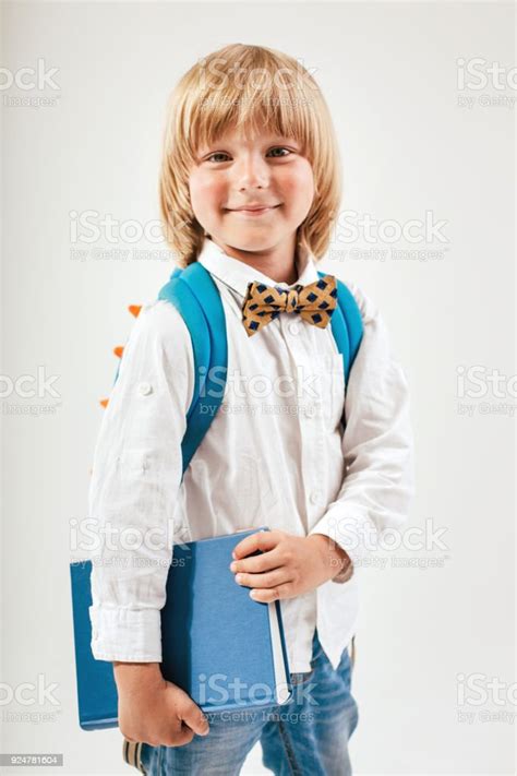 Portrait Of Happy Schoolboy With Books And Apple Isolated On White