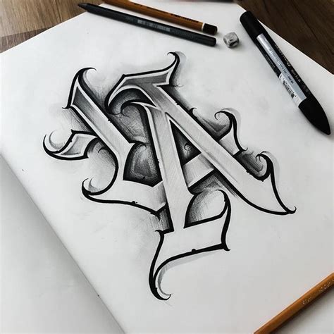 A Drawing Of The Letter A On Paper With Pencils