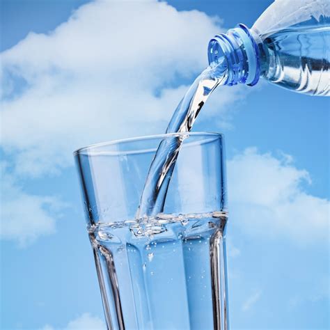 Premium Photo Pouring Drinking Water From Plastic Bottle Into Glass
