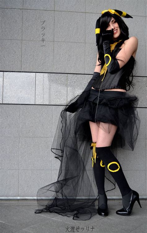 A Woman Dressed In Black And Yellow Posing For The Camera