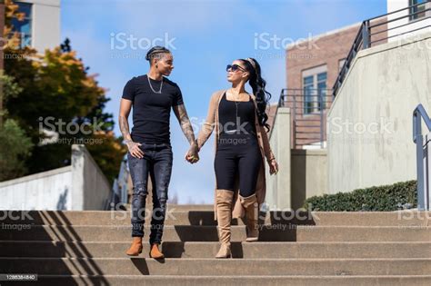 African American Lesbian Women Hold Hands And Walk Together Down Steps