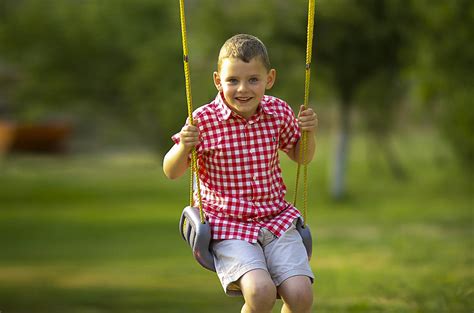 Children Playing On A Swing