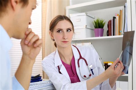 Female Medicine Doctor Explains To Male Patient Diagnosis Stock Photo