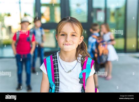 Portrait Of School Pupils Outside Classroom Carrying Bags Stock Photo