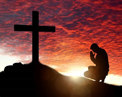 Silhouette Of Kneeling At The Cross Stock Photos Pictures And Royalty
