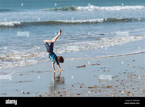 Boy Doing A Handstand On The Beach Stock Photo Alamy
