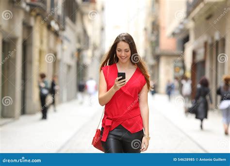 fashion woman walking and using a smart phone stock image image of adult happy 54628985