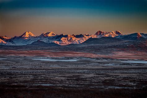 Frozen Tundra Near The Mountains During Sunset Alaska Travel Guide