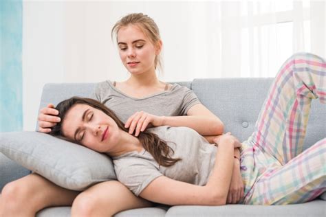 Free Photo Young Lesbian Woman Sleeping On Her Girlfriends Lap Sitting On Sofa At Home
