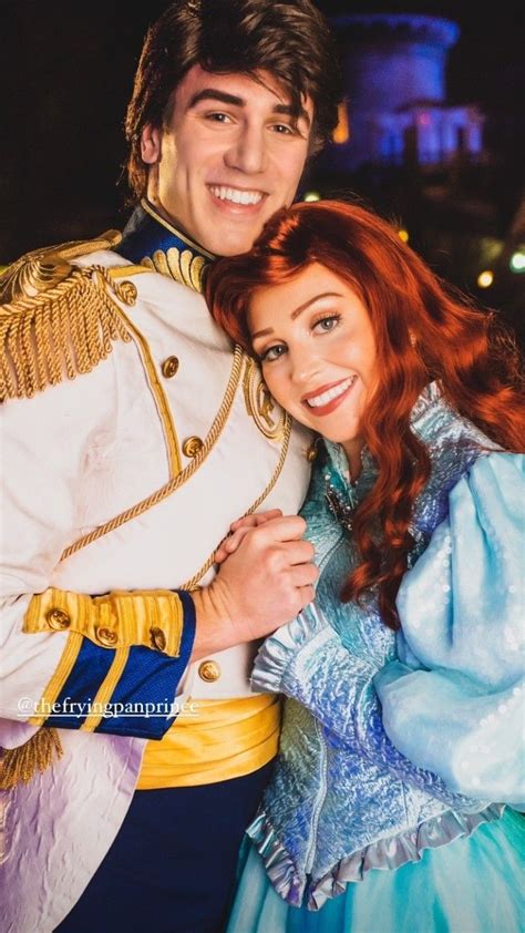 A Man And Woman Dressed As Disney Characters