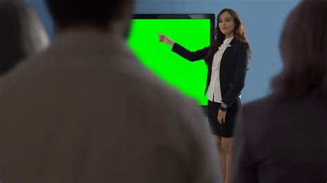 Young Woman Making Presentation In Office Against Green Screen Stock