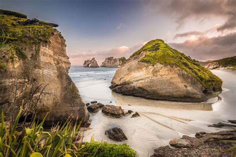 Wharariki Beach With The Archway Islands New Zealand Landscape Beach