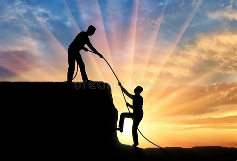 Silhouette Of A Man Helping Another Man Climb Up Stock Image Image