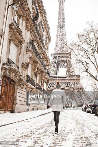Woman Walking To The Eiffel Tower With Snow High Res Stock Photo