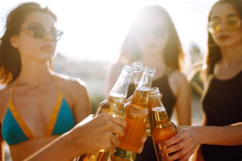 Premium Photo Nice Girls Cheers And Drink Beers On Beach At Sunset Four Girl In Bikini
