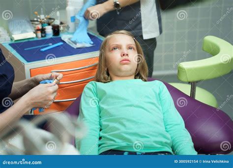 Little Scared Girl Sitting In Chair In Dentist Doctor Office Kidchild