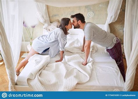 Couple Kissing In The Morning While Making The Bed. Bedroom, Morning, Togetherness, Concept ...