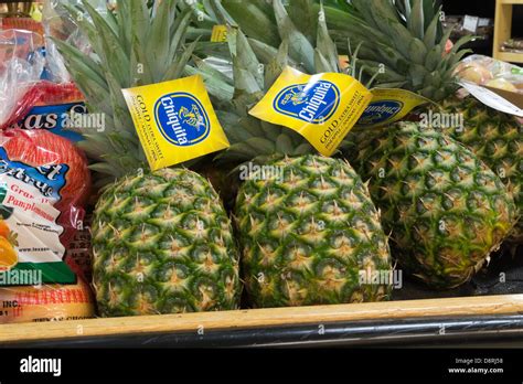 Pineapples On Display In A Grocery Store Stock Photo Alamy