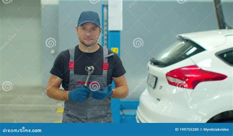 Handsome Professional Car Mechanic Is Working On A Vehicle In A Service