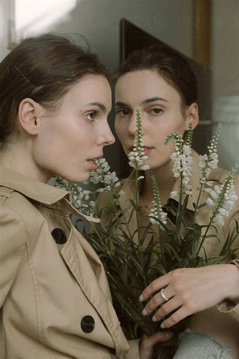 Portrait Of Twin Sisters Standing Next To Each Other With A Bouquet Of