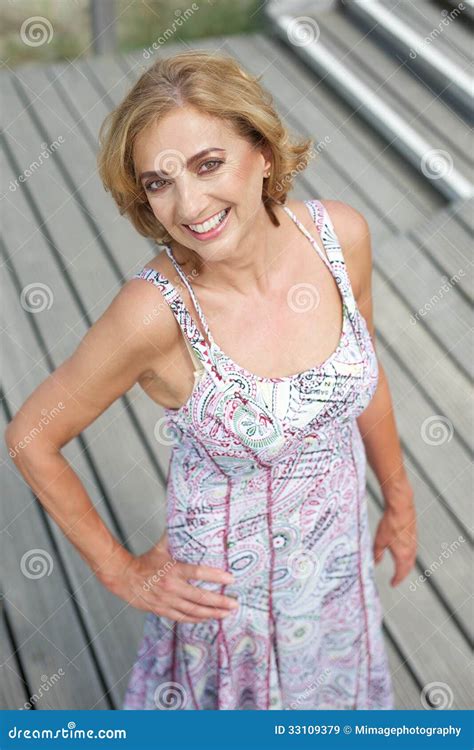 Beautiful Older Woman Posing Outdoors With A Smile Royalty Free Stock