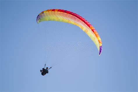 Performances On Paraglidinga Paraglider Flies In The Sky Under A Multi