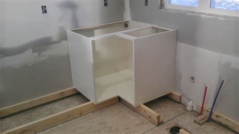 When beginning a diy kitchen cabinet install, always start in a corner where two runs of assembled kitchen cabinets will come together. Once Upon an Acre: Installing the kitchen base cabinets