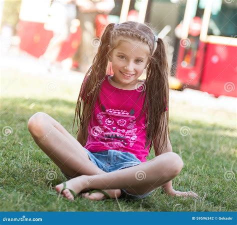Małej Dziewczynki Obsiadanie Na Trawie Zdjęcie Stock Obraz Złożonej Z