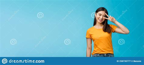 friendly cheerful asian girlfriend look joy happiness show peace victory sign smiling toothy