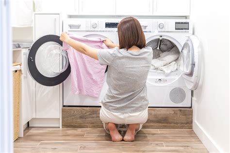 Premium Photo Woman Putting Clothes To Washing Machine For Wash