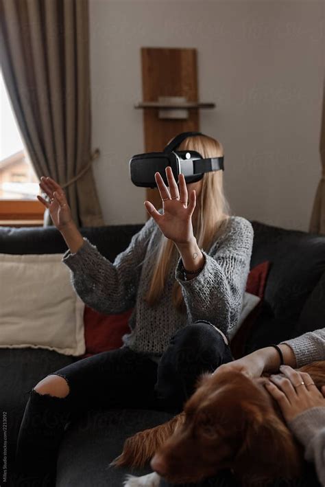 Woman In Vr Headset With Hands Up By Milles Studio Playing Video