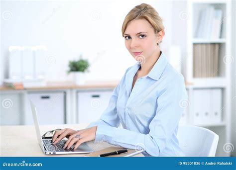 Young Blonde Business Woman With Laptop In The Office Business Concept