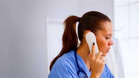 Premium Photo Medical Receptionist Answering Phone Calls From Patient
