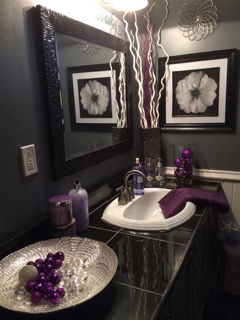 Here, a rich eggplant shade continues in honeycomb floor tiles. Black and grey bathroom with lavender accents | Purple bathroom decor, Purple bathrooms, Gray ...