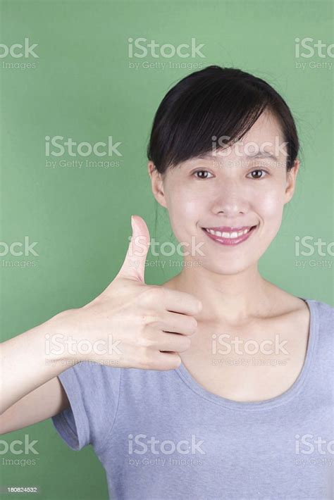 Closeup Of A Young Asian Woman Showing Thumbs Up Stock Photo Download