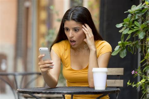 Attractive Latin Woman Shocked On Her Smart Phone Stock Image Image