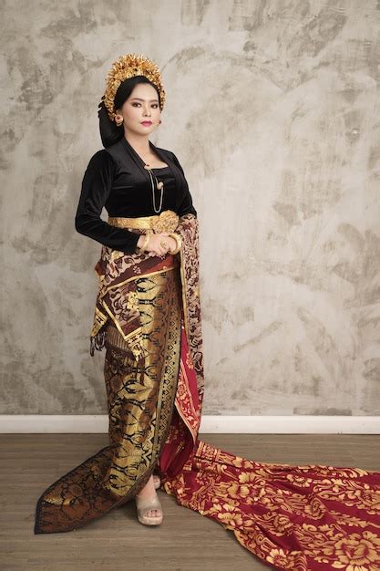 premium photo woman wearing balinese kebaya woven cloth with patterned wall background