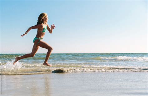 Babe Girl Running At The Beach By Stocksy Contributor Raymond Forbes LLC Stocksy