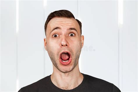 Funny Young Surprised Guy With Opened Mouth And Wide Eyes Stock Photo