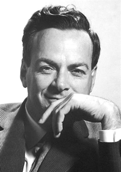 A Black And White Photo Of A Man In A Suit With His Hand On His Chin